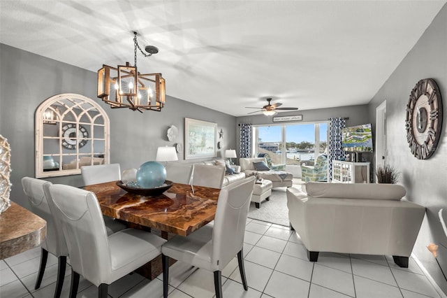dining area with ceiling fan with notable chandelier and light tile patterned floors