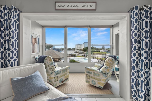 living area featuring tile patterned flooring and plenty of natural light