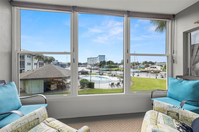 sunroom / solarium with a water view
