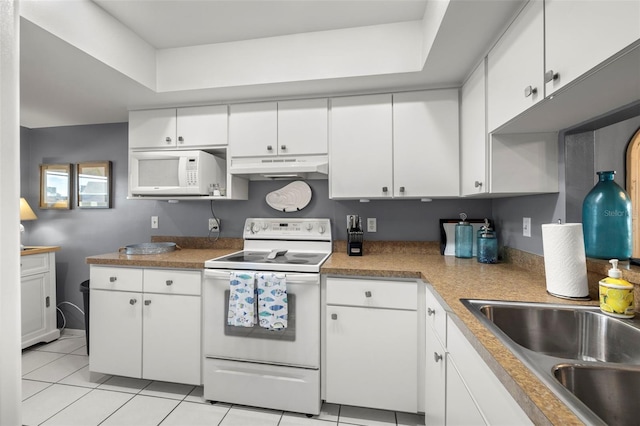 kitchen featuring white cabinets, light tile patterned flooring, a sink, white appliances, and under cabinet range hood