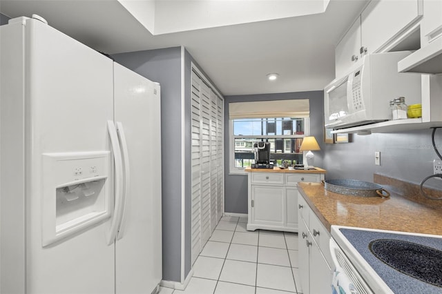 kitchen with light tile patterned flooring, white appliances, light countertops, white cabinetry, and baseboards
