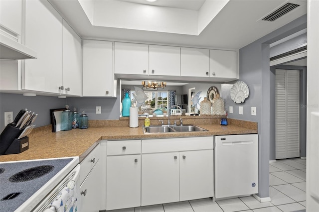 kitchen featuring light tile patterned flooring, an inviting chandelier, a sink, dishwasher, and visible vents