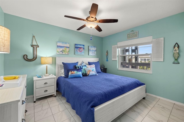 bedroom featuring baseboards, ceiling fan, and marble finish floor