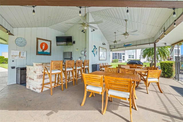 view of patio / terrace with a bar and a ceiling fan