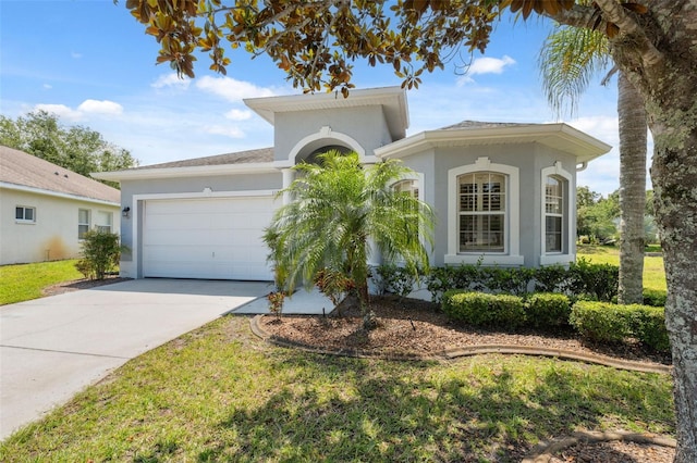 11220 Godwit Ct, New Port Richey, FL 34654 - view of front of house with an attached garage, driveway, stucco siding, and a front lawn