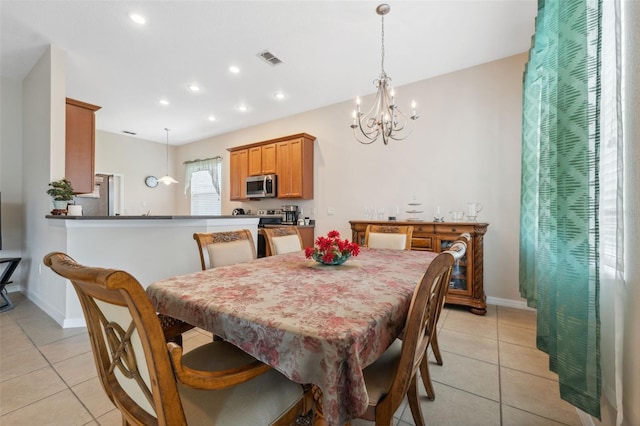 11220 Godwit Ct, New Port Richey, FL 34654 - dining space with a chandelier, light tile patterned floors, recessed lighting, and baseboards
