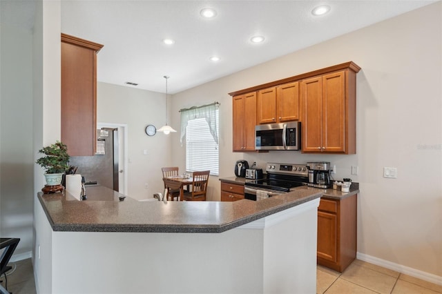 11220 Godwit Ct, New Port Richey, FL 34654 - kitchen with appliances with stainless steel finishes, dark countertops, recessed lighting, brown cabinetry, and a peninsula
