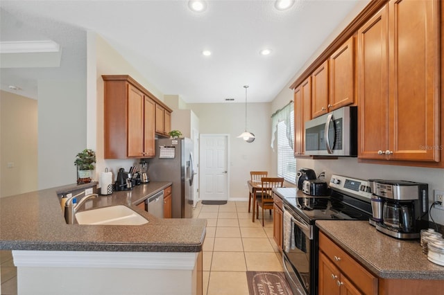 11220 Godwit Ct, New Port Richey, FL 34654 - kitchen with appliances with stainless steel finishes, a sink, dark countertops, brown cabinets, and recessed lighting