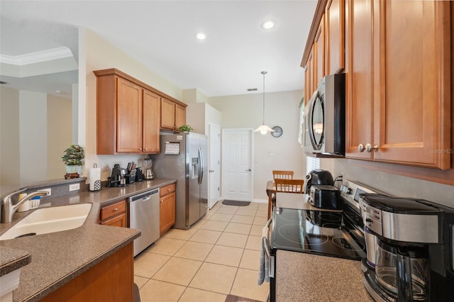 11220 Godwit Ct, New Port Richey, FL 34654 - kitchen with stainless steel appliances, a sink, brown cabinetry, dark countertops, and light tile patterned flooring