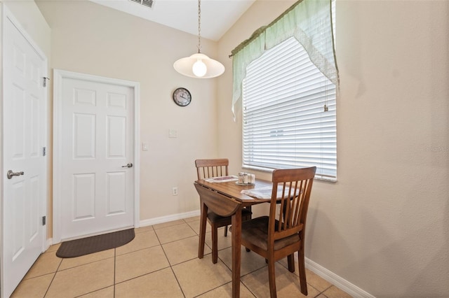 11220 Godwit Ct, New Port Richey, FL 34654 - dining space featuring light tile patterned floors, plenty of natural light, and baseboards