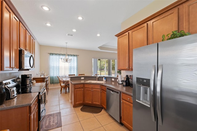 11220 Godwit Ct, New Port Richey, FL 34654 - kitchen with appliances with stainless steel finishes, recessed lighting, dark countertops, brown cabinetry, and a sink