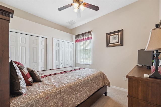 11220 Godwit Ct, New Port Richey, FL 34654 - bedroom featuring multiple closets, carpet, baseboards, and ceiling fan