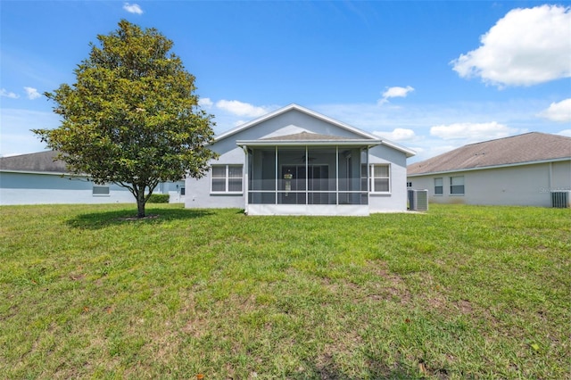 11220 Godwit Ct, New Port Richey, FL 34654 - back of property with a lawn, central AC unit, and a sunroom