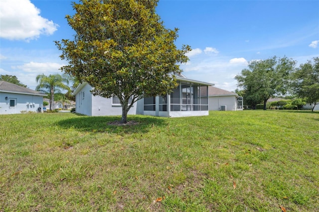11220 Godwit Ct, New Port Richey, FL 34654 - view of grassy yard with a sunroom