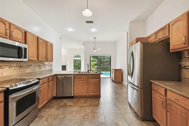 1831 Stable Trl, Palm Harbor, FL 34685 - kitchen featuring decorative backsplash, a ceiling fan, pendant lighting, appliances with stainless steel finishes, and a sink