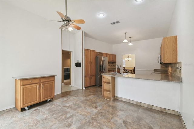 1831 Stable Trl, Palm Harbor, FL 34685 - kitchen featuring stainless steel fridge, a sink, a ceiling fan, vaulted ceiling, and visible vents