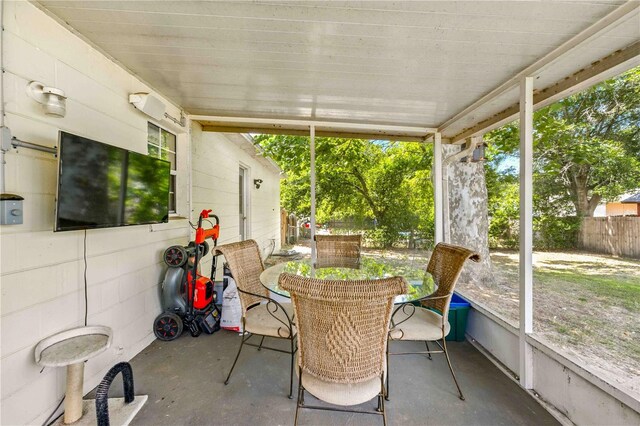 sunroom with outdoor dining area