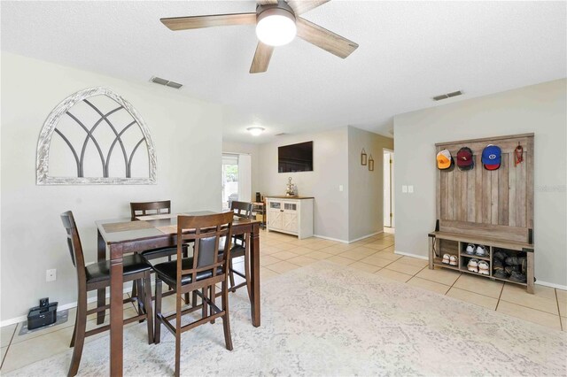 tiled dining area with ceiling fan, visible vents, and baseboards