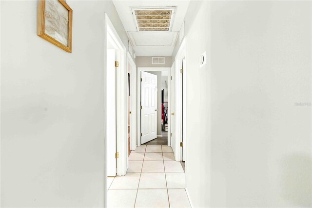 corridor with visible vents and light tile patterned floors