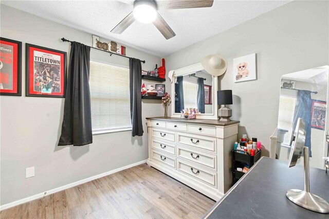 bedroom featuring baseboards, ceiling fan, and light wood-style flooring