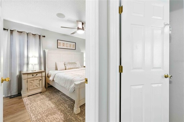 bedroom with a ceiling fan and light wood-style flooring