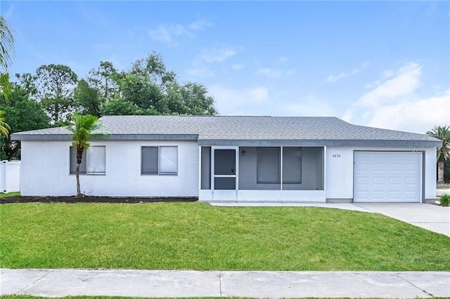 ranch-style home featuring a garage, stucco siding, a shingled roof, a front yard, and driveway