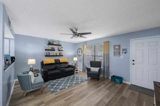 404 Hammock Pine Blvd Unit 404, Clearwater, FL 33761 - living area with a textured ceiling, ceiling fan, baseboards, and wood finished floors