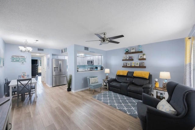 404 Hammock Pine Blvd Unit 404, Clearwater, FL 33761 - living area with a textured ceiling, visible vents, ceiling fan with notable chandelier, and light wood-style floors
