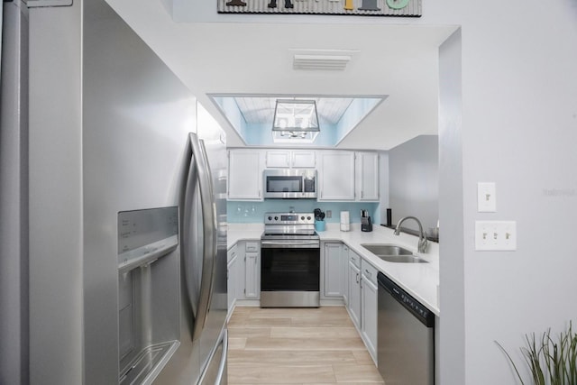 404 Hammock Pine Blvd Unit 404, Clearwater, FL 33761 - kitchen featuring visible vents, light wood-type flooring, light countertops, a sink, and stainless steel appliances