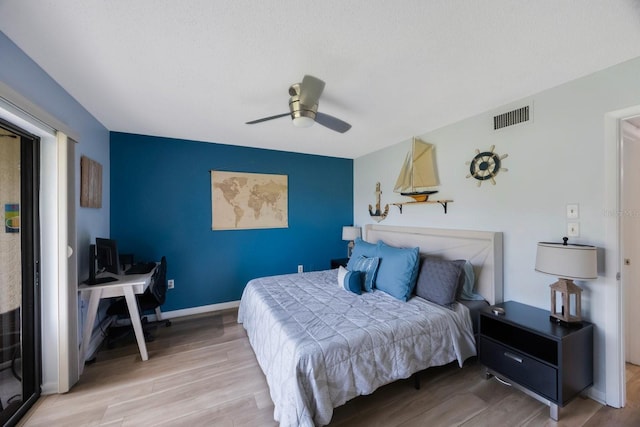 404 Hammock Pine Blvd Unit 404, Clearwater, FL 33761 - bedroom featuring visible vents, an accent wall, wood finished floors, baseboards, and ceiling fan