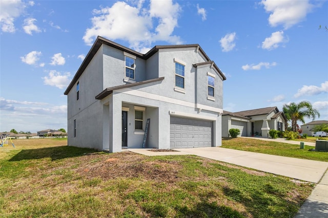 view of front of house with a garage, stucco siding, a front yard, and concrete driveway