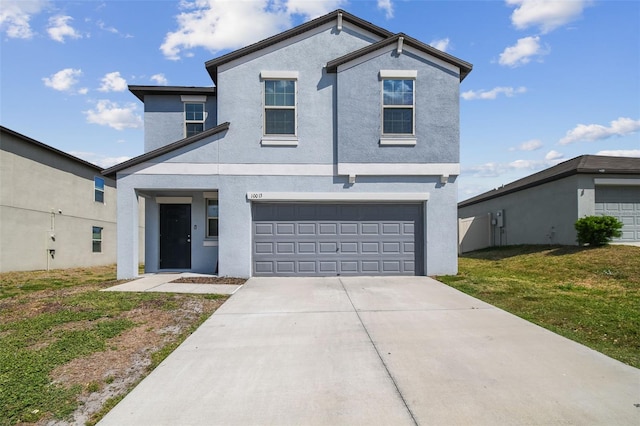 view of front facade featuring a garage, a front lawn, stucco siding, and concrete driveway