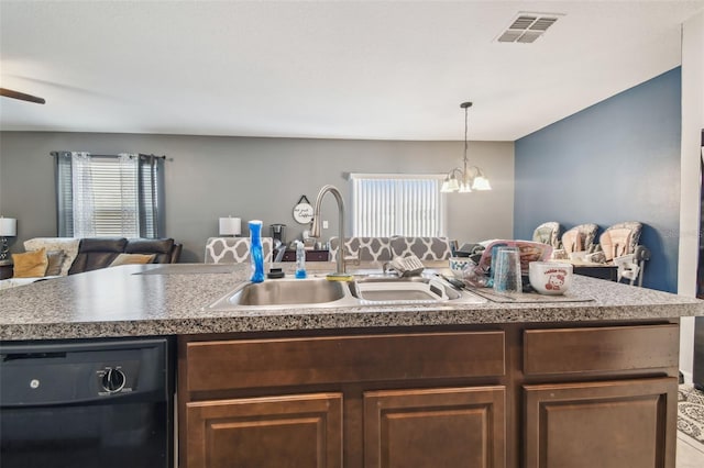 kitchen featuring visible vents, an inviting chandelier, open floor plan, a sink, and dishwasher