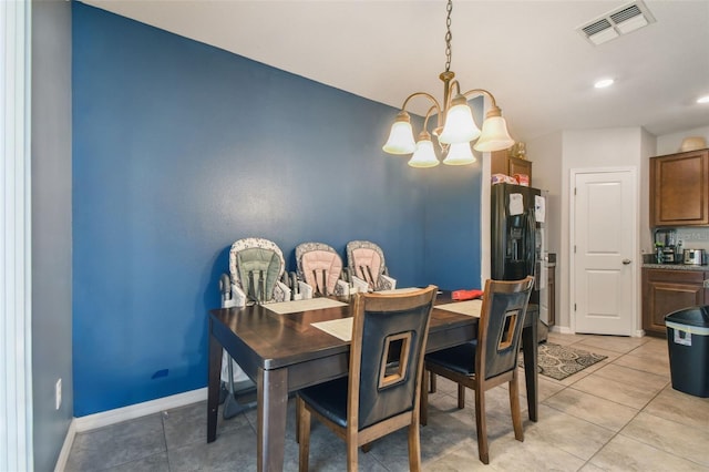dining area featuring visible vents, baseboards, light tile patterned floors, and an inviting chandelier