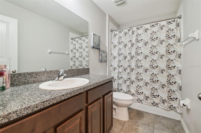 full bathroom featuring vanity, baseboards, tile patterned floors, and toilet