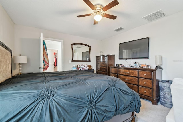 bedroom with ceiling fan, visible vents, a spacious closet, and carpet