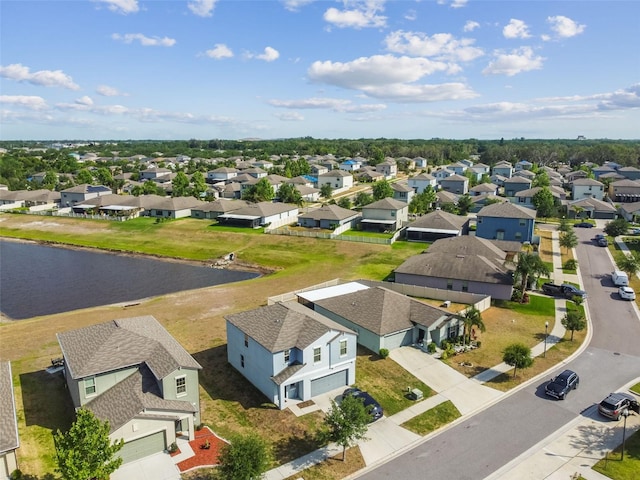 birds eye view of property featuring a water view and a residential view