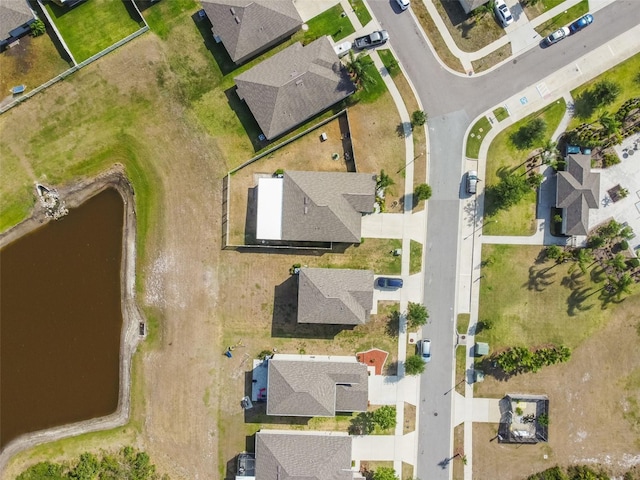 birds eye view of property featuring a water view and a residential view