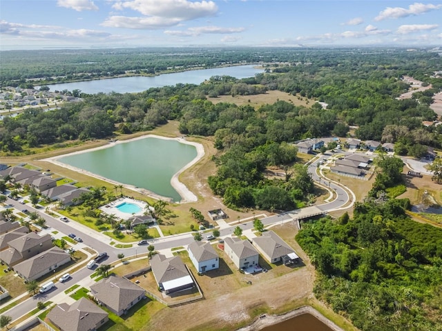 bird's eye view with a water view, a residential view, and a wooded view