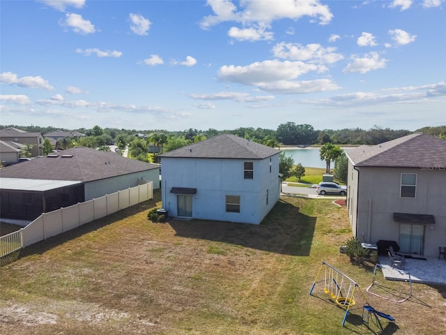 back of house featuring fence and a yard