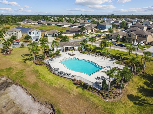 community pool with a residential view and fence