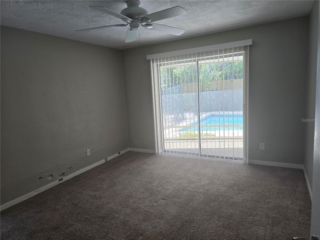 carpeted empty room with baseboards, a ceiling fan, and a textured ceiling