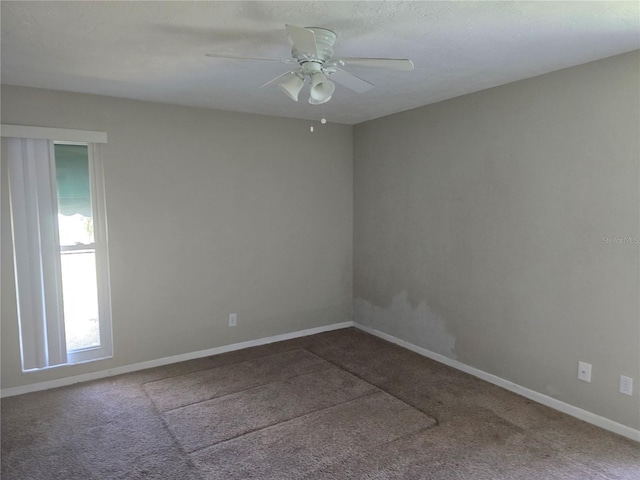 spare room with baseboards, a ceiling fan, and carpet flooring