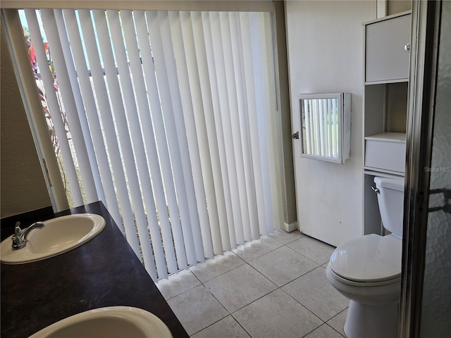 full bathroom featuring a sink, tile patterned floors, and toilet