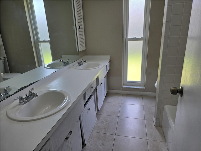 full bathroom featuring a sink, tile patterned flooring, and double vanity