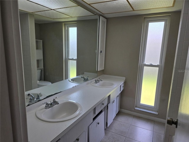 bathroom featuring a wealth of natural light, a sink, and tile patterned flooring