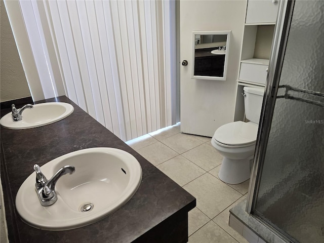 full bathroom with toilet, tile patterned floors, a shower stall, and a sink