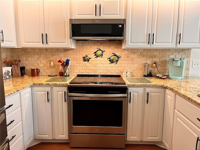 kitchen featuring backsplash, appliances with stainless steel finishes, and white cabinetry