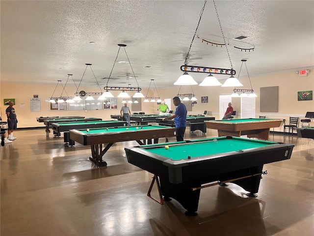 playroom with a textured ceiling and pool table