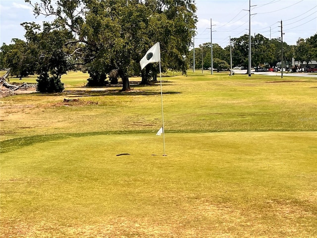 view of community with a lawn and golf course view